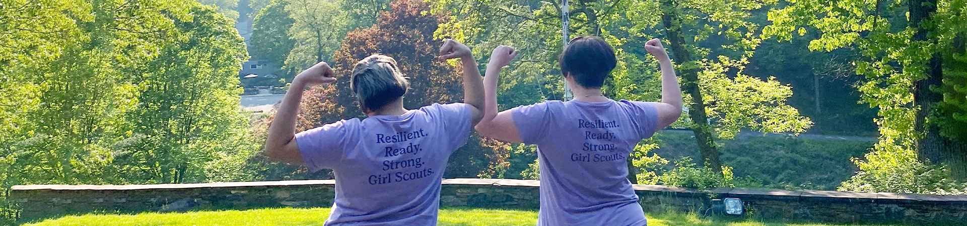  girl scout staff or volunteer wearing adult vest in woods smiling 